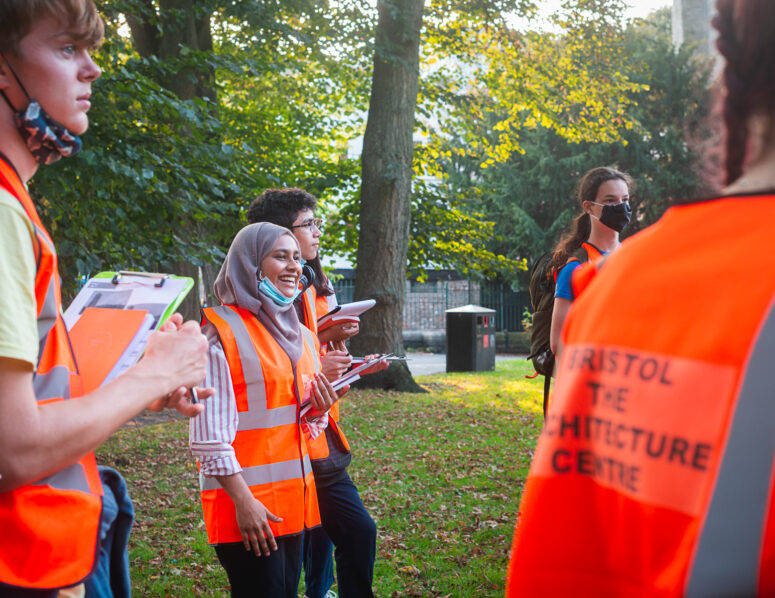 Students gathered in Temple Church Gardens wearing high vis carrying clipboards